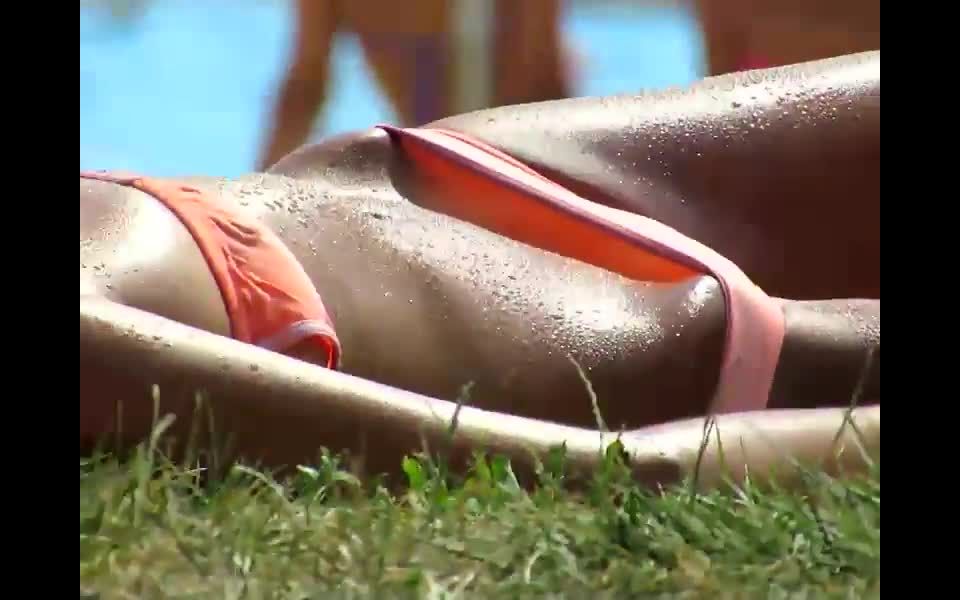 Wet girl's bikini bridge by the pool